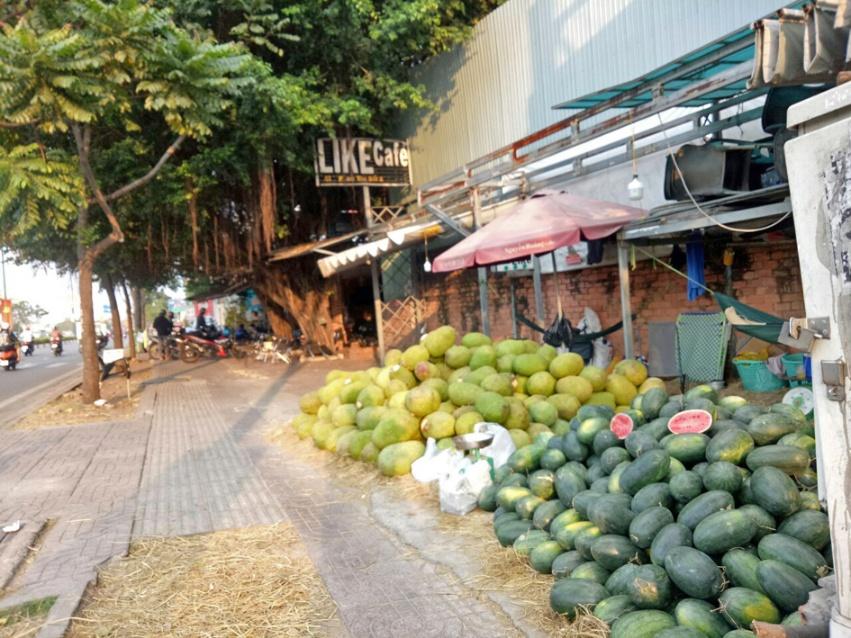 Mít thái, dưa hấu… chất thành đống với giá 8.000 đồng/kg tại vỉa hè đường Phạm Văn Đồng, Thủ Đức nhưng ít khách mua - ẢNH: Q.BÌNH